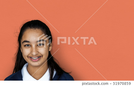 Portrait studio shoot of schoolgirl in uniform with smiling 31970859