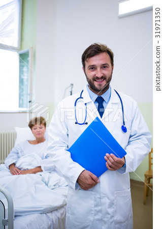 Smiling doctor holding a medical report 31971350