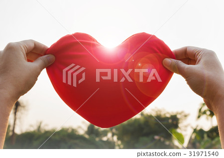 hand gently raise up red heart, love concept hand gently raise up red heart, love concept 31971540