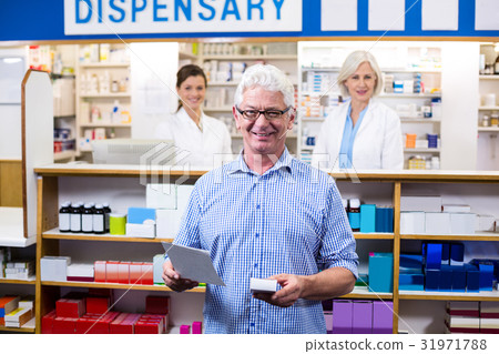 Customer holding prescription while checking medicine in pharmacy 31971788
