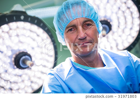 Portrait of surgeon standing in operation room 31971803