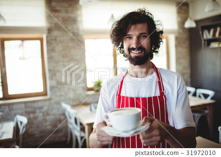 Male baker holding a cup of coffee 31972010
