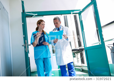 Doctor and nurse checking medical report Doctor and nurse checking medical report 31972021
