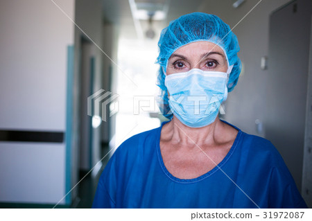 Portrait of surgeon standing in corridor Portrait of surgeon standing in corridor 31972087