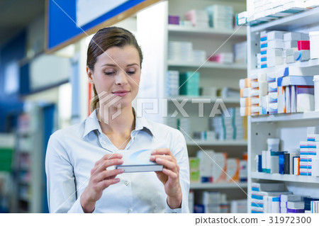 Pharmacist checking a medicine box 31972300