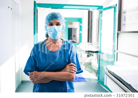 Surgeon standing in corridor at hospital 31972301
