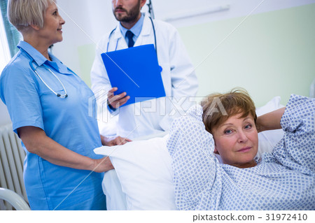 Portrait of smiling patient lying on bed Portrait of smiling patient lying on bed 31972410