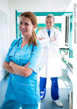 Portrait of doctor and nurse standing with arms crossed Portrait of doctor and nurse standing with arms crossed 31972530