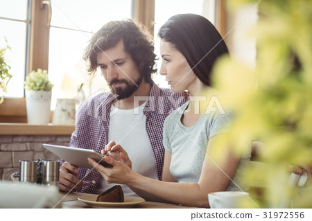 Couple using digital tablet 31972556
