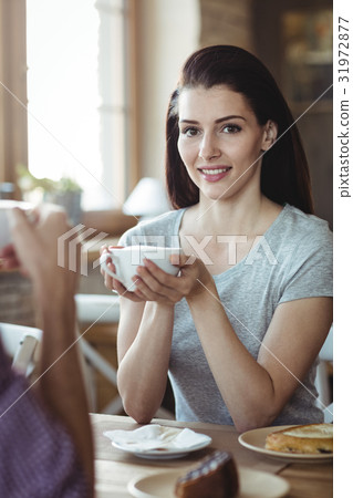 Woman holding a cup of coffee 31972877