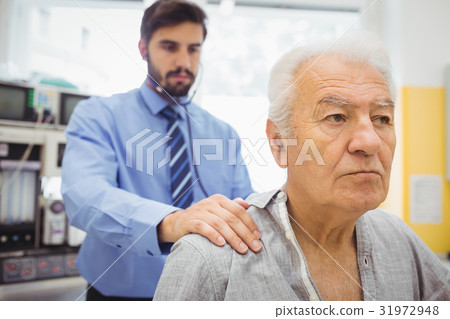 Male doctor examining a patient 31972948