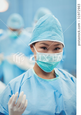 Portrait of female surgeon preparing for operation in operation room 31972983