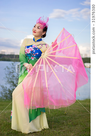 chinese girl in traditional chinese dress with fan chinese girl in traditional chinese dress with fan 31976380