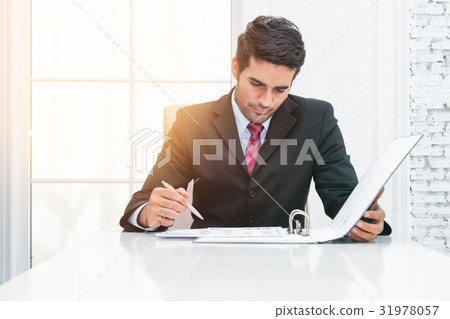 businessman signing contract paper at desk 31978057