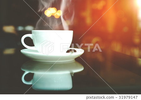 cup of coffee and smoke on table in cafe 31979147