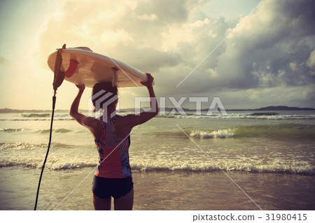 Young woman surfer with surfboard ready to surf 31980415