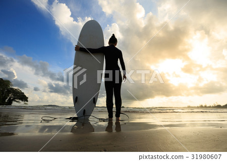 Young woman surfer with surfboard ready to surf Young woman surfer with surfboard ready to surf 31980607