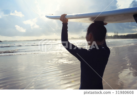 Young woman surfer with surfboard ready to surf 31980608