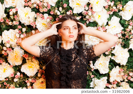 Sexy woman on flower background in studio photo. Sexy woman on flower background in studio photo. 31982006