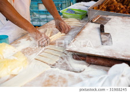 Man cooks youtiao at the street market 31988245