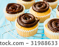 Mini sweet cupcakes with chocolate ganache 31988633