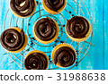 Tasty cupcakes on the blue background 31988638