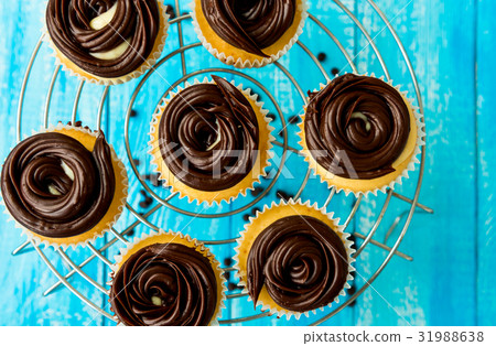 Tasty cupcakes on the blue background 31988638