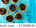 Homemade tasty cupcakes with cream and chocolate 31988640