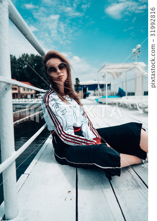 Young beautiful girl posing on the pier 31992816