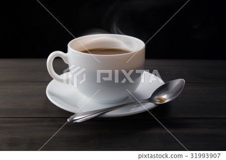 White coffee cup with smoke on black background White coffee cup with smoke on black background 31993907