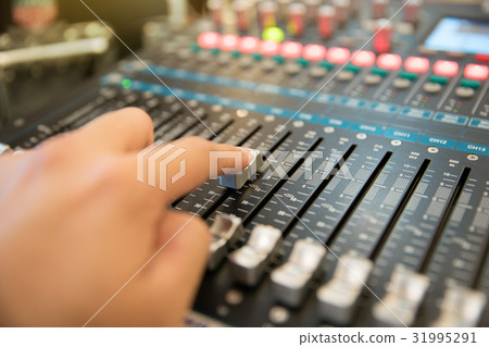 hand using audio mixing console hand using audio mixing console 31995291