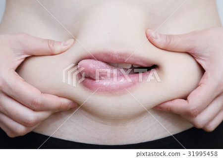 woman grab her belly with her ready to eat mouth woman grab her belly with her ready to eat mouth 31995458