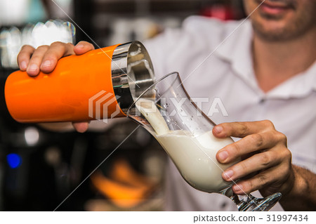 Bartender making a cocktail with fresh fruit Bartender making a cocktail with fresh fruit 31997434
