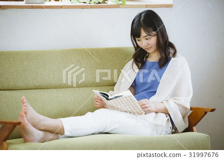 A woman reading on a sofa 31997676