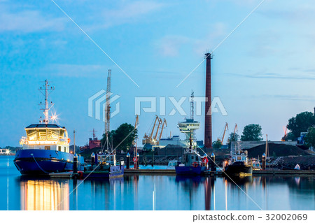 Blue tug ship moored Blue tug ship moored 32002069