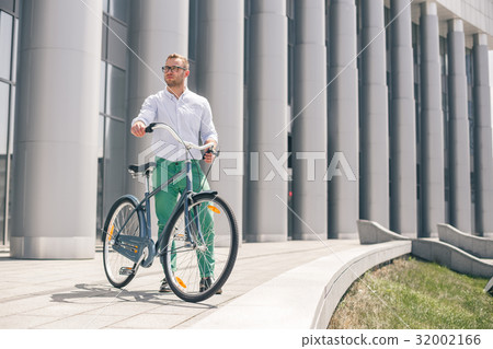 Handsome hipster enjoying city ride by bicycle Handsome hipster enjoying city ride by bicycle 32002166
