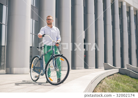 Handsome hipster enjoying city ride by bicycle Handsome hipster enjoying city ride by bicycle 32002174