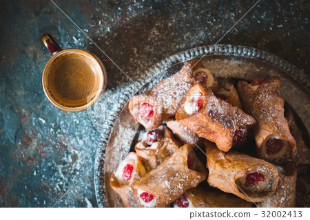 Cannoli and cup of coffee on the stone background Cannoli and cup of coffee on the stone background 32002413