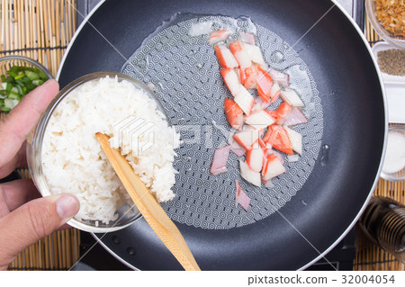 Chef put cooking rice to pan Chef put cooking rice to pan 32004054