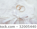 gold wedding rings on a pillow 32005440