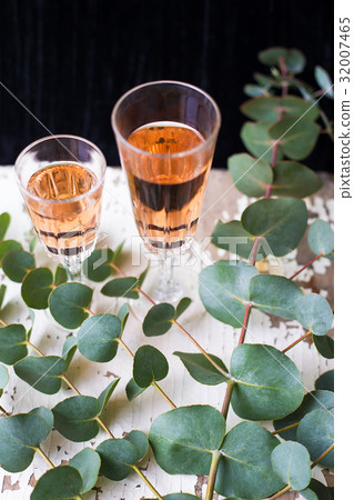 eucalyptus branches on an old table with a glass eucalyptus branches on an old table with a glass 32007465