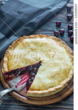 Cherry pie on the wooden background 32008497