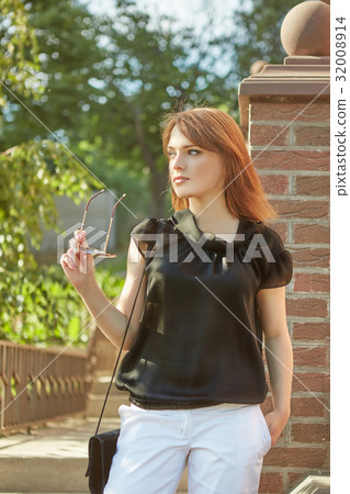 Beautiful young woman outdoors. Beautiful young woman outdoors. 32008914