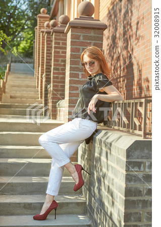 Beautiful young woman outdoors. 32008915