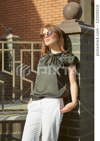 Beautiful young woman outdoors. 32008916