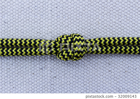 Rope knot on white sailcloth background 32009143