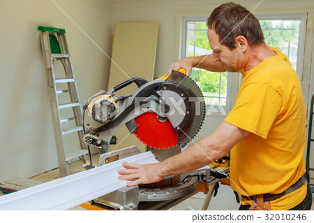 Contractor Circular Saw Cutting Crown Moulding 32010246