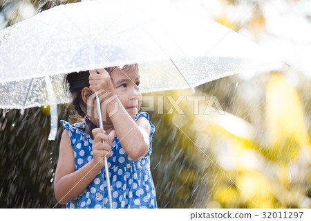 Happy asian little girl with umbrella in rain 32011297