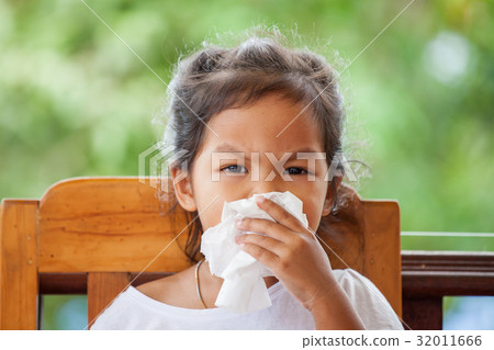 asian girl wiping or cleaning nose with tissue asian girl wiping or cleaning nose with tissue 32011666