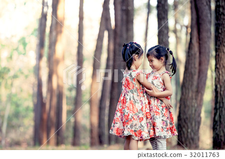 Two asian little girls having fun to play together Two asian little girls having fun to play together 32011763